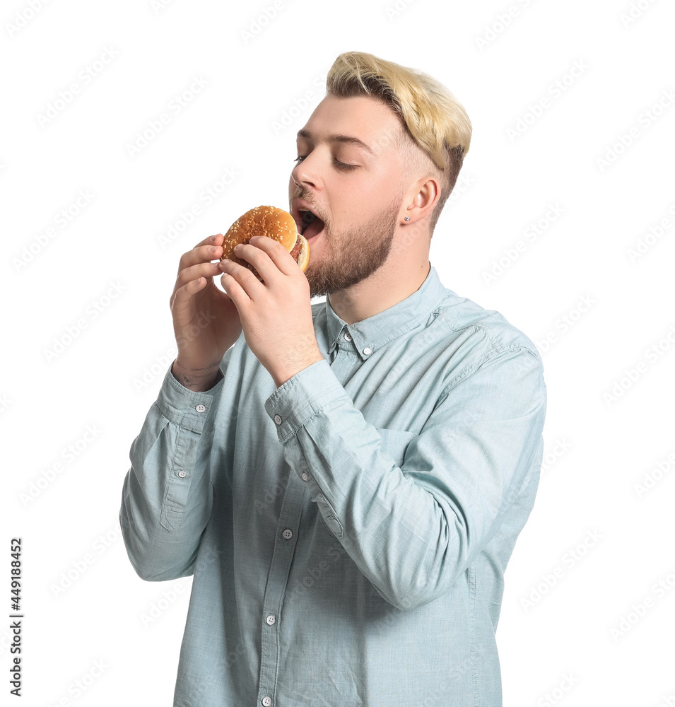 Young man eating vegan burger on white background Young man eating vegan burger on white background
