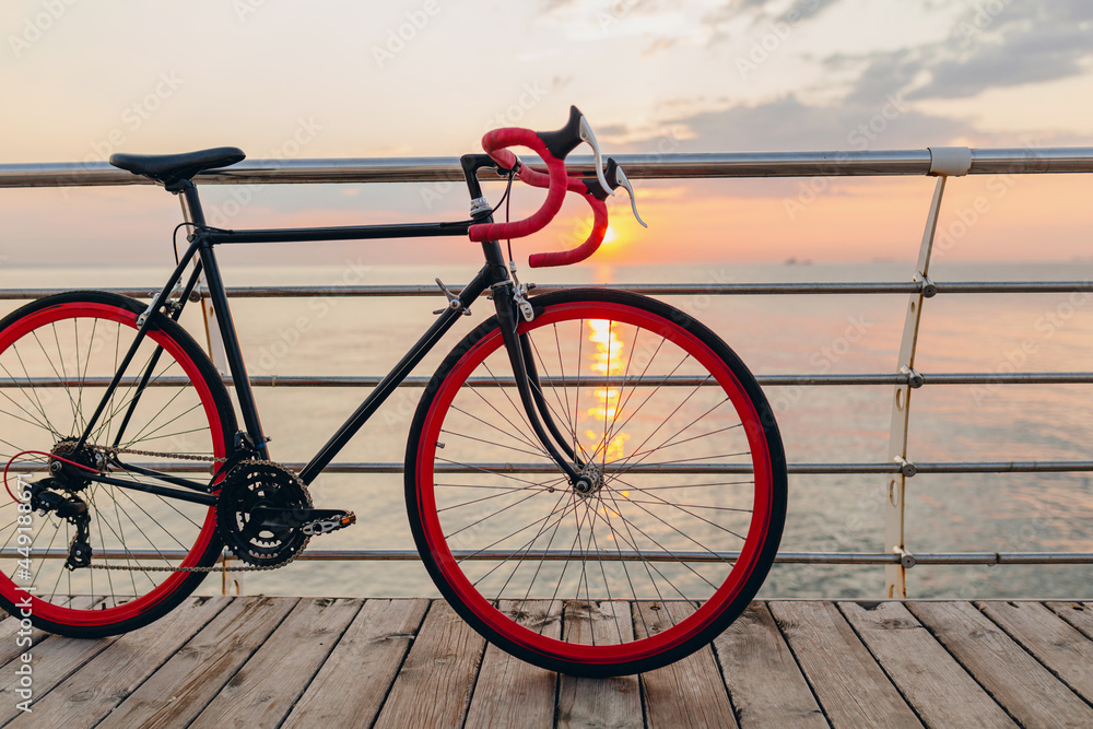 Fototapeta premium hipster bicycle in morning sunrise by the sea