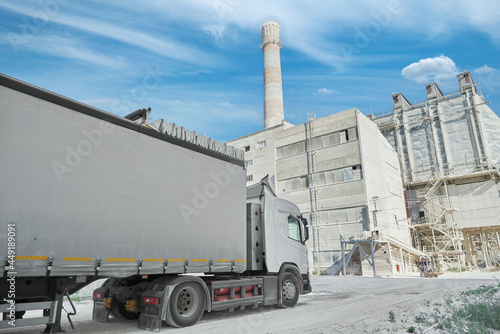 A truck with a long body is waiting for loading at a chalk factory.