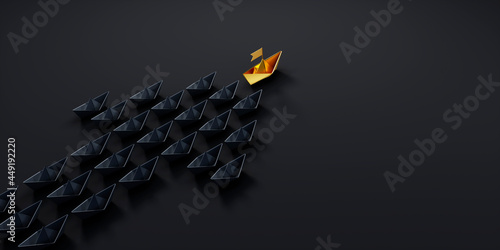 Fotografia, Obraz Arrow shaped group of black paper boats on a dark background with a single golde