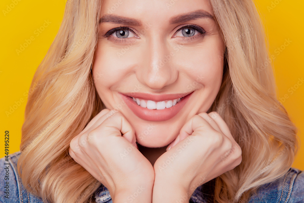 Portrait of cheerful tempting lady fists cheeks look camera beaming white smile on yellow background Portrait of cheerful tempting lady fists cheeks look camera beaming white smile on yellow background