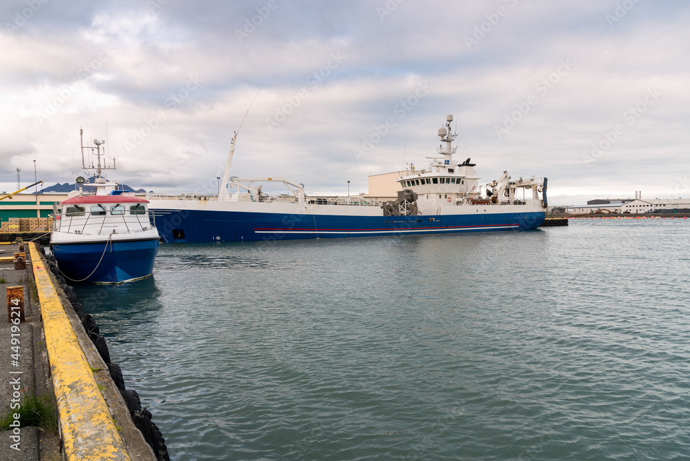 Fish factory ship moored in a harbour in Iceland on a cloudy summer day