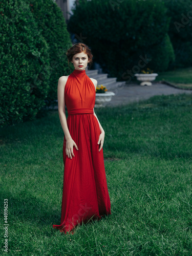 woman in red dress in garden nature charm fashion © SHOTPRIME STUDIO