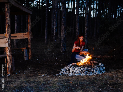 woman sitting in nature near the campfire rest forest