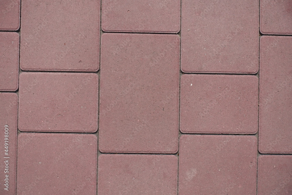 Fototapeta premium Close view of pavement made of pink concrete blacks