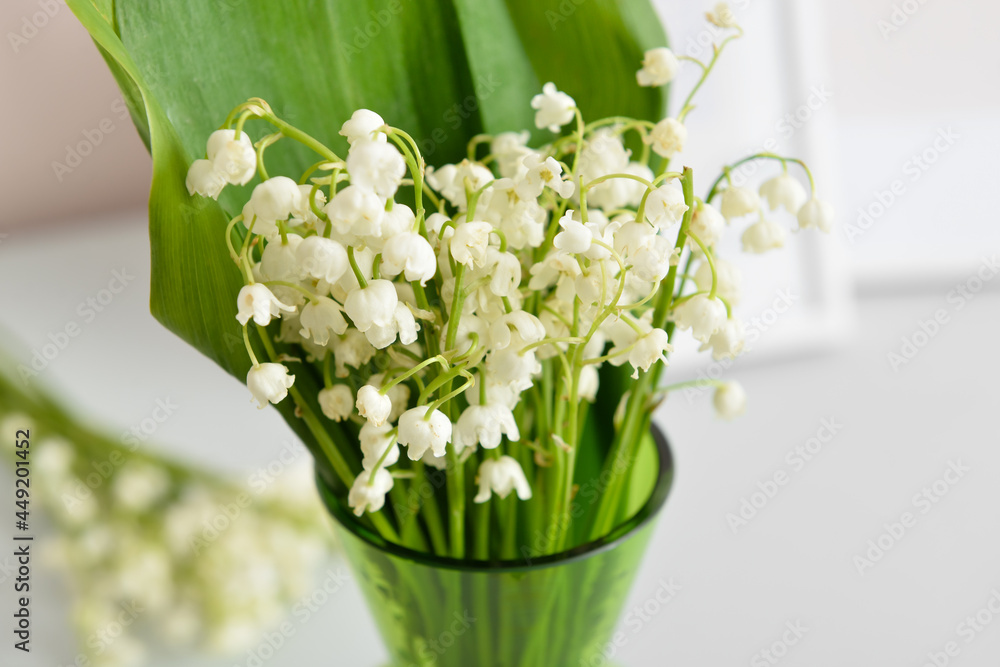 Vase with lily-of-the-valley flowers on shelf, closeup Vase with lily-of-the-valley flowers on shelf, closeup