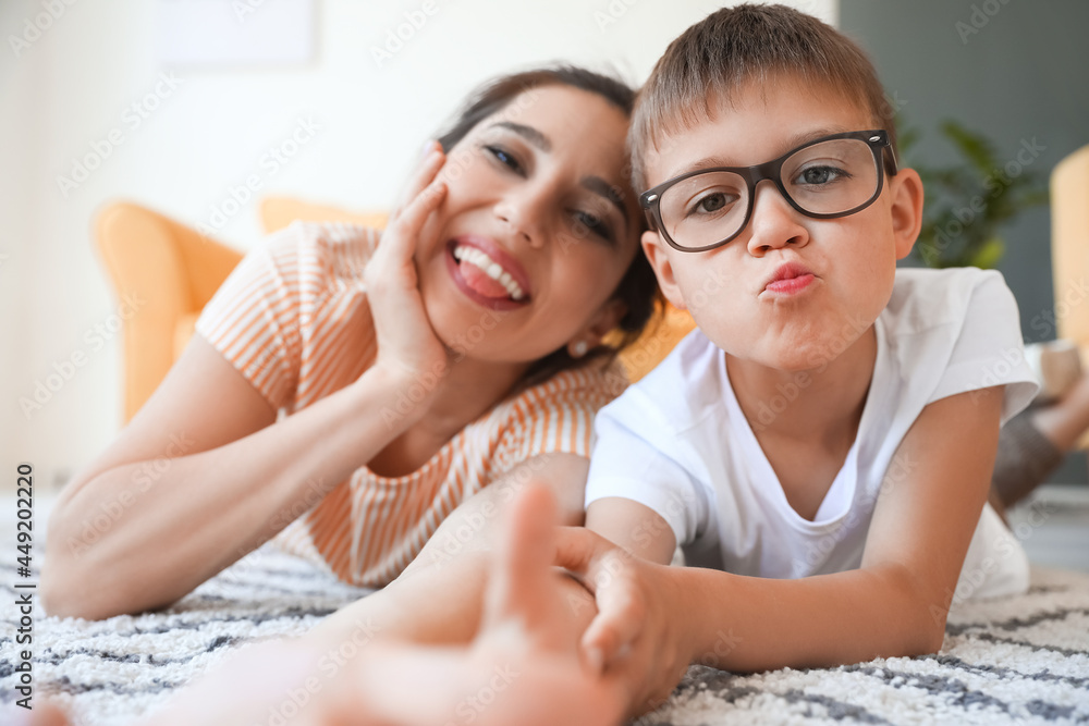 Young woman and her little son taking selfie at home Young woman and her little son taking selfie at home