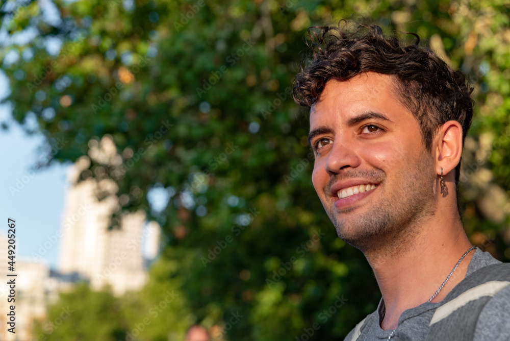 Portrait of young latin man outdoors with a bag. Portrait of young latin man outdoors with a bag.