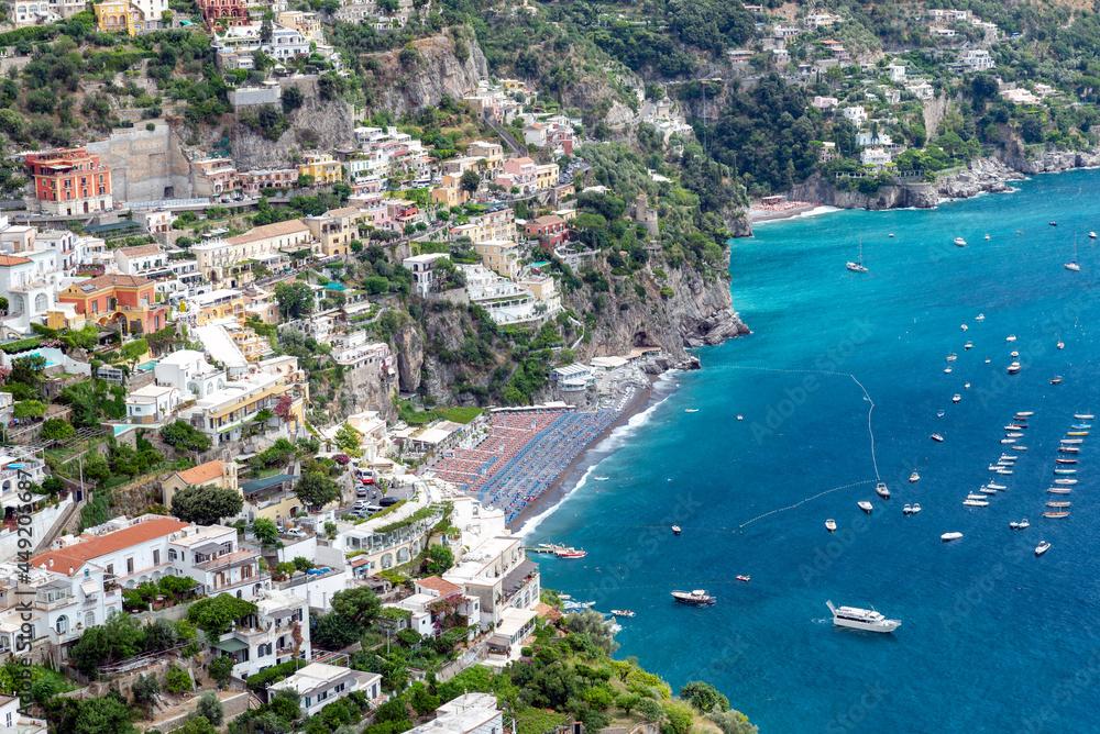  Positano's Main Beach on the Amalfi coast in  hot summer day, with full  boats sea