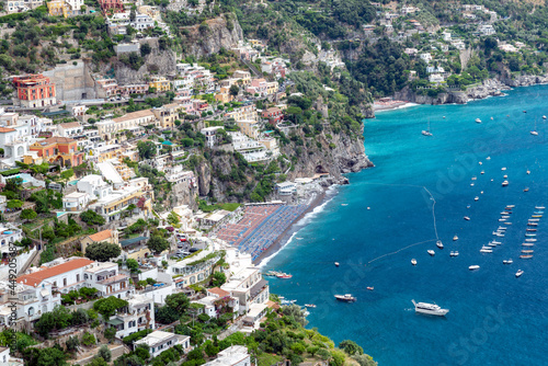  Positano's Main Beach on the Amalfi coast in hot summer day, with full boats sea