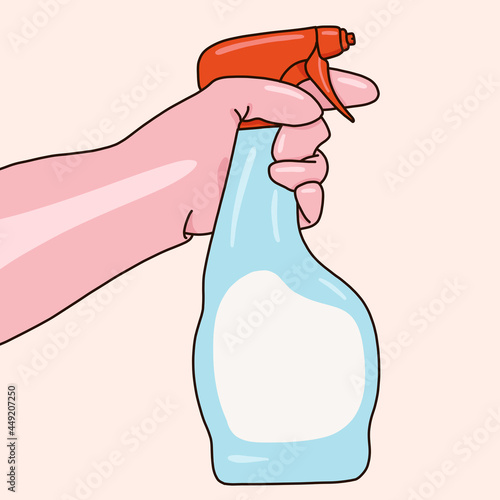 Hand with gloves holding a cleaning spray photo