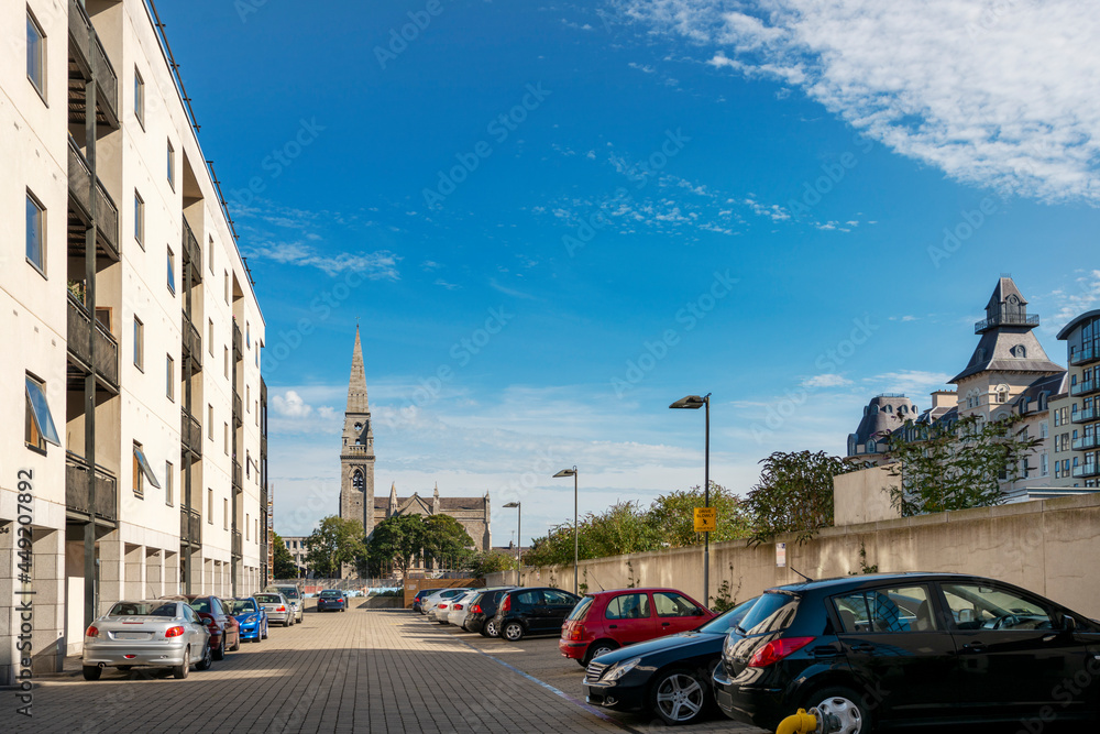 Obraz premium South Dublin residential area with neo-gothic church on a lovely clear Ireland summer day