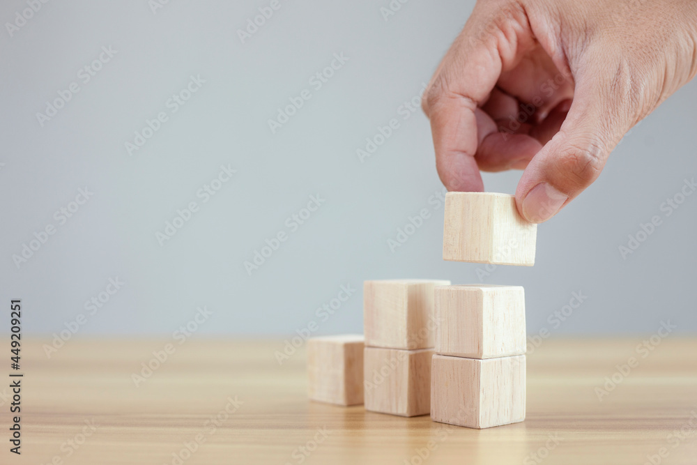 Business concept growth success process, closeup hand arranging wood cube stacking as step stair, copy space Business concept growth success process, closeup hand arranging wood cube stacking as step stair, copy space