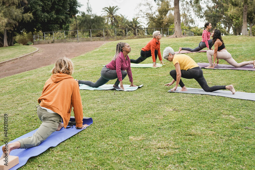 Multiracial people doing yoga at park - Concept of healthy lifestyle, sport and multi generational people