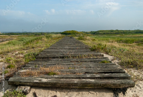 Old wooden pathway in the countryside with a beautiful misty sky - Costa Nova Beach  Aveiro  Portugal  10.06.2021