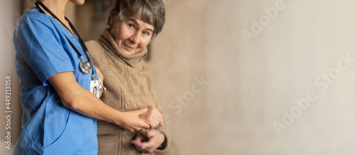 A young nurse shows care and professionalism in relation to an elderly woman