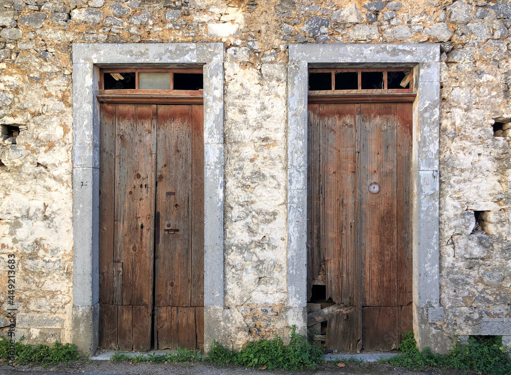 Wooden doors on old façade in Kastelli Fournis, Crete, Greece