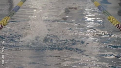 Young latin girl swimming away