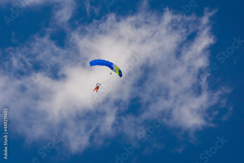 blue parachute against the background of blue sky and clouds