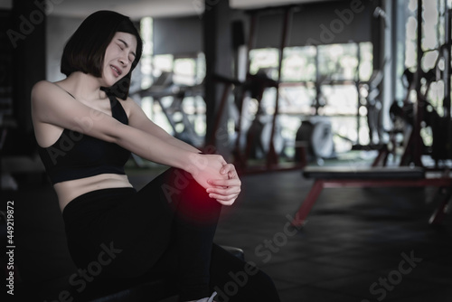 Asian slim woman play fitness at the gym,She pain from exercise