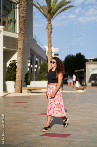 Young woman with sunglasses walking around the city