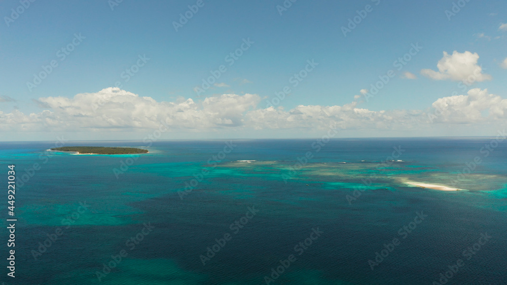 Obraz premium Islands are surrounded by an atoll and a coral reef with blue water top view. Summer and travel vacation concept. Siargao,Philippines.