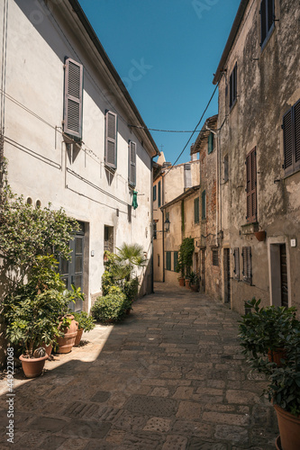 narrow alley in picturesque tuscan village of Capalbio © schame87
