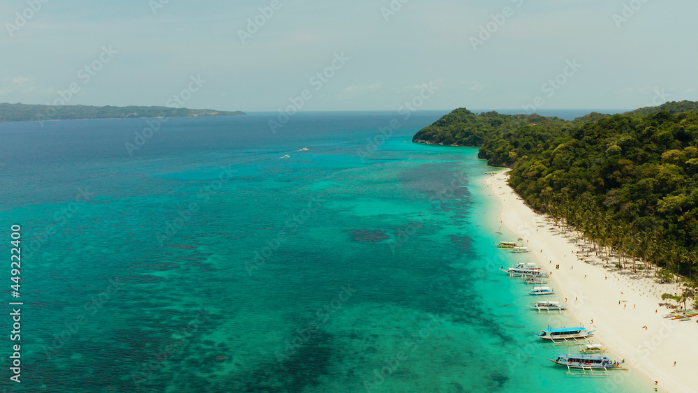 Fototapeta premium Aerial seascape: Tropical beach with palm trees and turquoise waters of the coral reef, from above, Puka shell beach. Boracay, Philippines. Seascape with beach on tropical island. Summer and travel