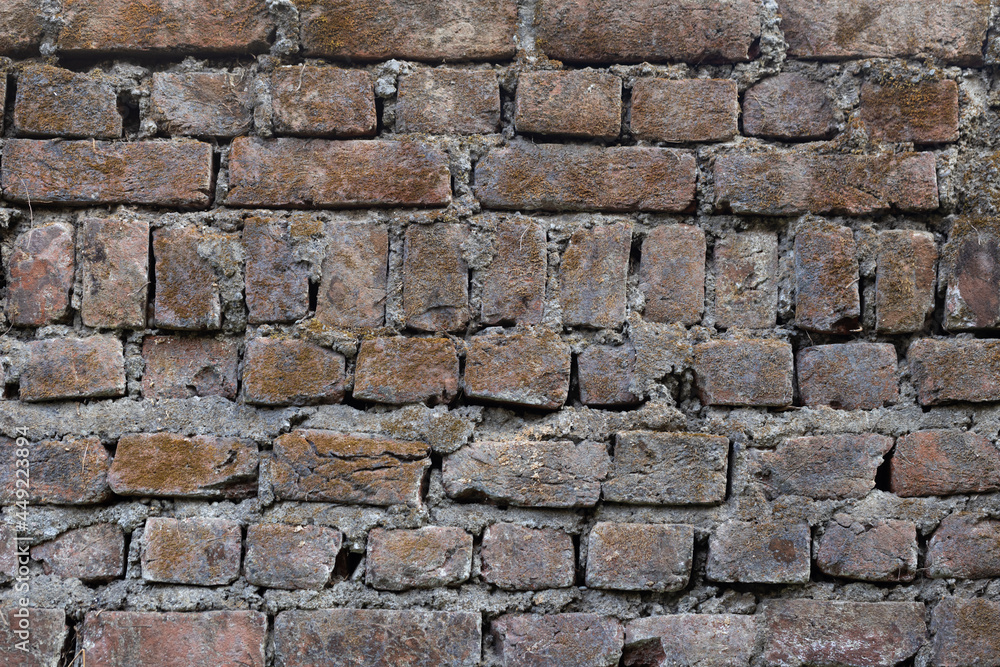 A weathered and old brick wall with similar pattern as a background