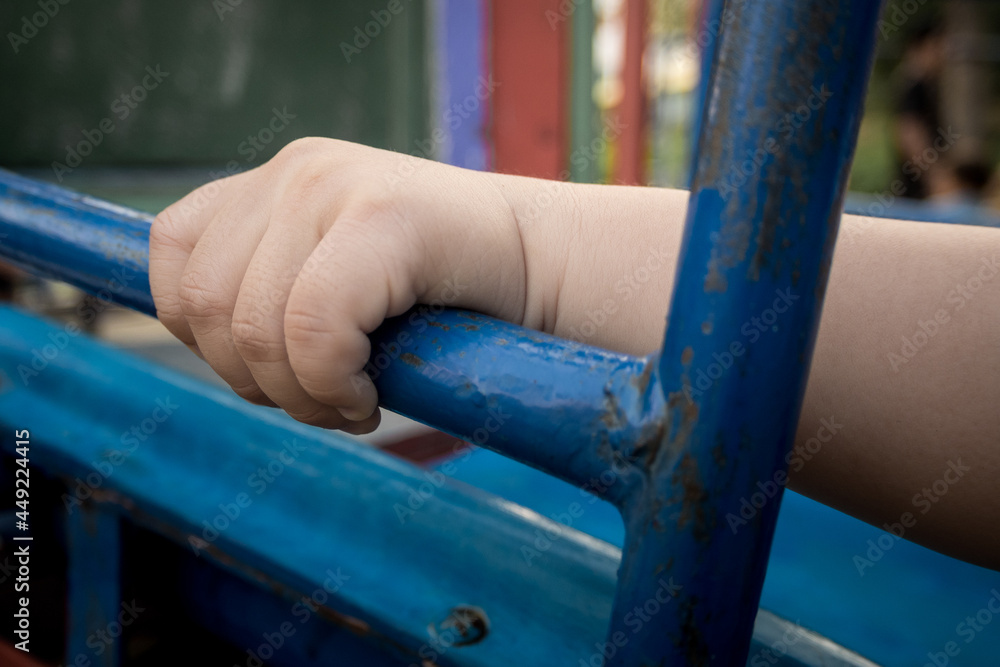 Child hand holding handlebar steel