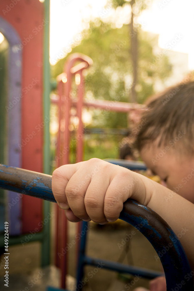 Child hand holding handlebar steel