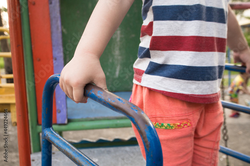 Child hand holding handlebar steel