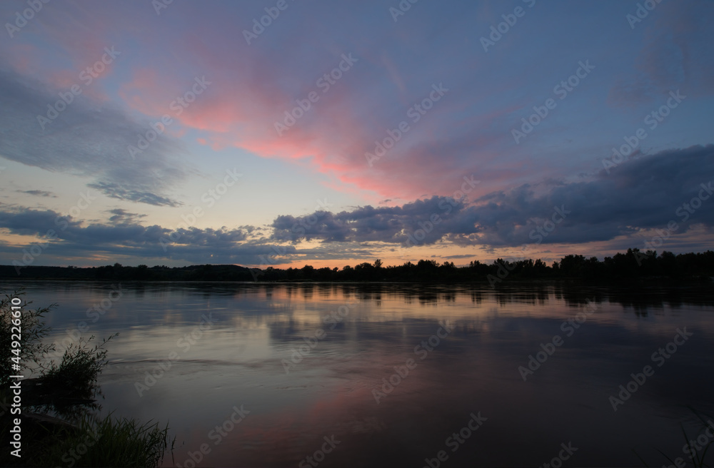 Cloudy sunset over Wisła river in Kazimierz Dolny in Poland.