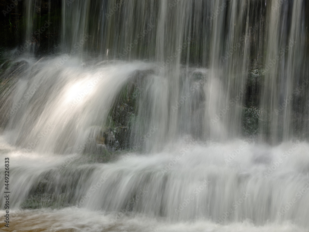 The beautiful Wagner Falls located in Michigans Upper Peninsula in the summer with cool flowing and smooth water The beautiful Wagner Falls located in Michigans Upper Peninsula in the summer with cool flowing and smooth water