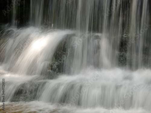 The beautiful Wagner Falls located in Michigans Upper Peninsula in the summer with cool flowing and smooth water