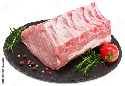 Wallpaper Mural raw pork meat with rosemar, tomato and peppercorn on black round stone plate isolated on white background. Clipping path and full depth of field Torontodigital.ca