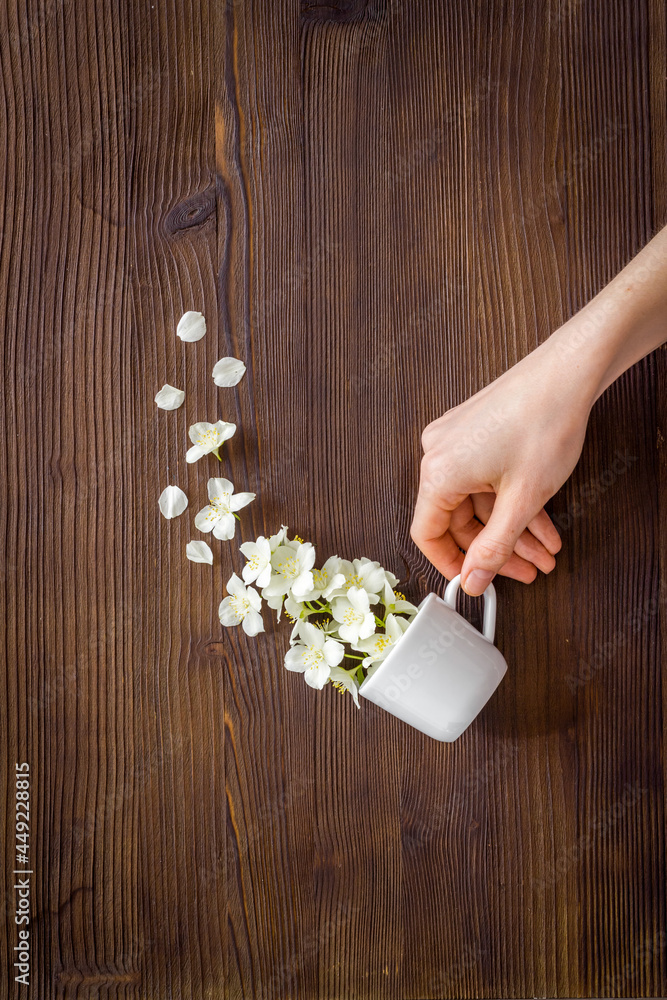 Jasmine fall into a cup. Herbal tea concept. Floral background Jasmine fall into a cup. Herbal tea concept. Floral background