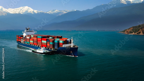 container cargo ship and tugboat floating carrying commercial container in import export business commerce logistic and transportation of international by container ship open sea