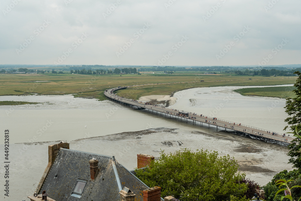 The arrival trail to the famous Mont Saint-Michel Abbey at high tide in the Manche department, Normandy region, France