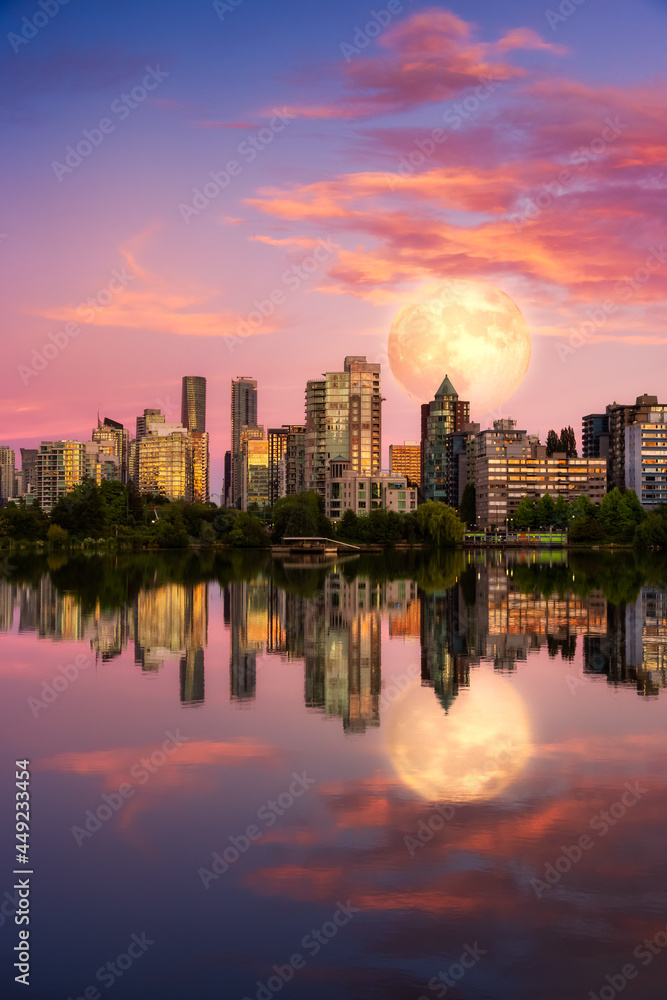 View of Lost Lagoon in famous Stanley Park in a modern city with buildings skyline in background. Colorful Sunset Sky. Artistic Full Moon Composite Render. Downtown Vancouver, BC, Canada.