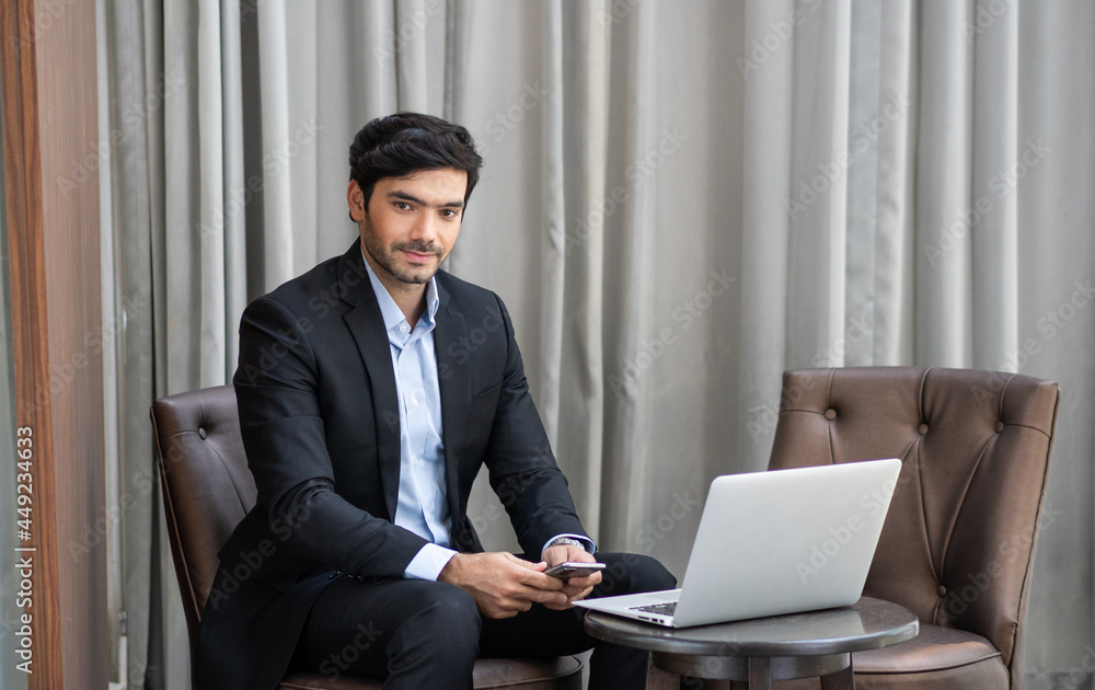 Businessman in suit with laptop sitting at seat looking at camera. business people having meeting or working remotely Businessman in suit with laptop sitting at seat looking at camera. business people having meeting or working remotely