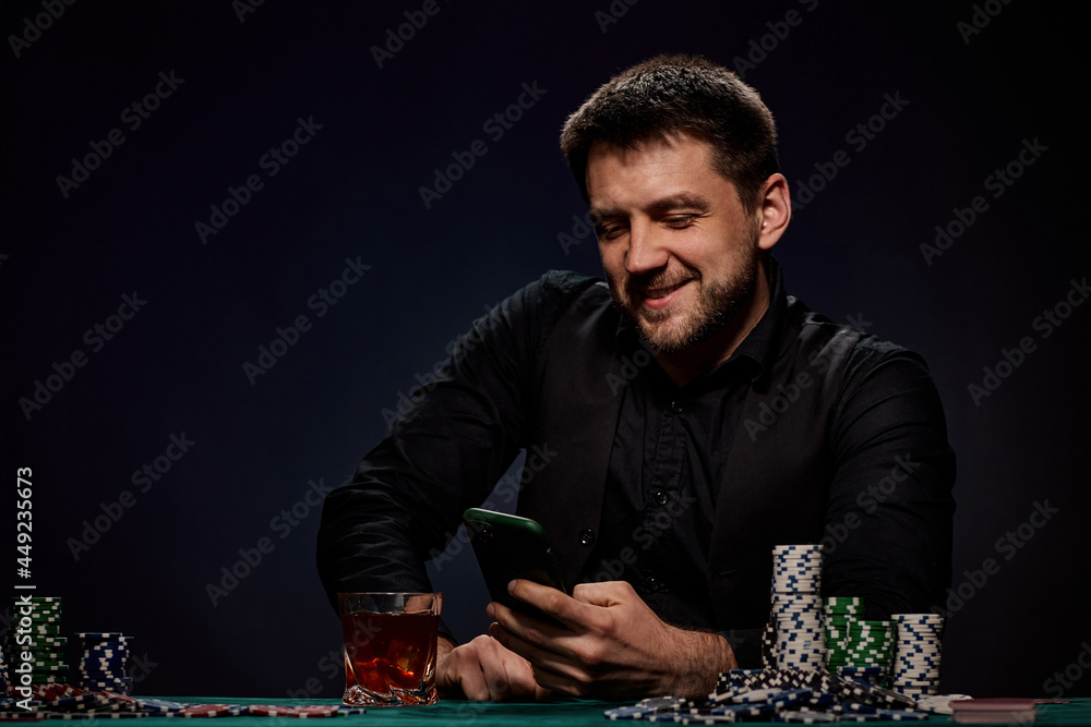 Bearded casino player man playing poker on green table Bearded casino player man playing poker on green table