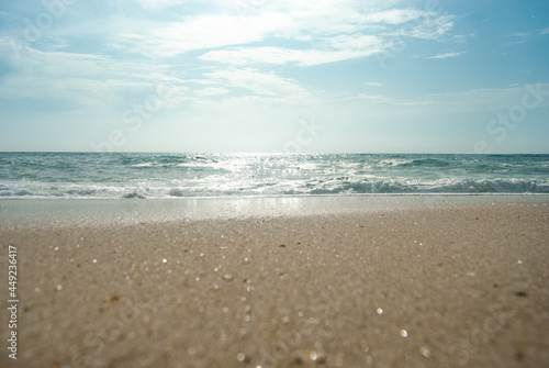 Panoramic shot of an ocean waves, beautiful sand sparkling at the sun © Galina