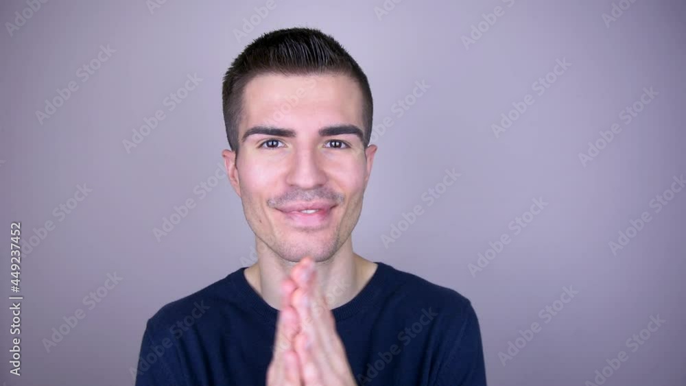 The smiling man rubs his hands together as a sign of satisfaction The smiling man rubs his hands together as a sign of satisfaction