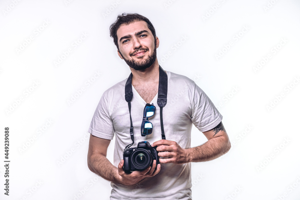 Man holding camera. Boy takes photo in studio. Professional photographer. Hobbies and leisure