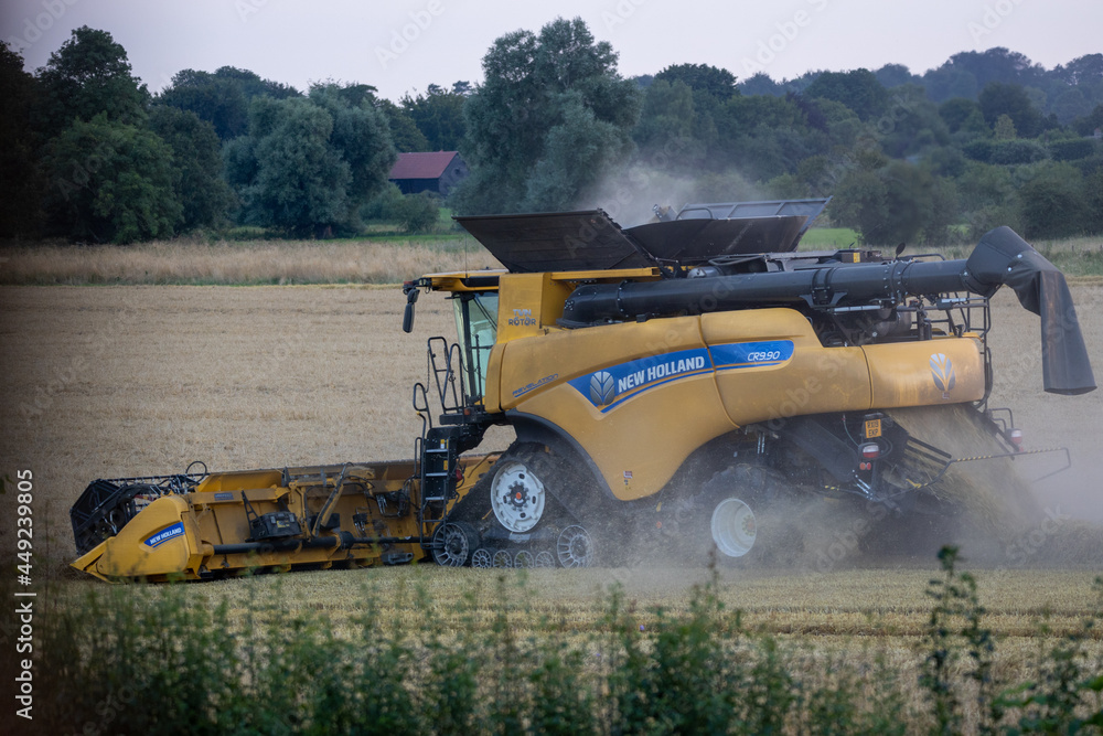 Combine harvester at work harvesting barley. Avebury Wiltshire Stock