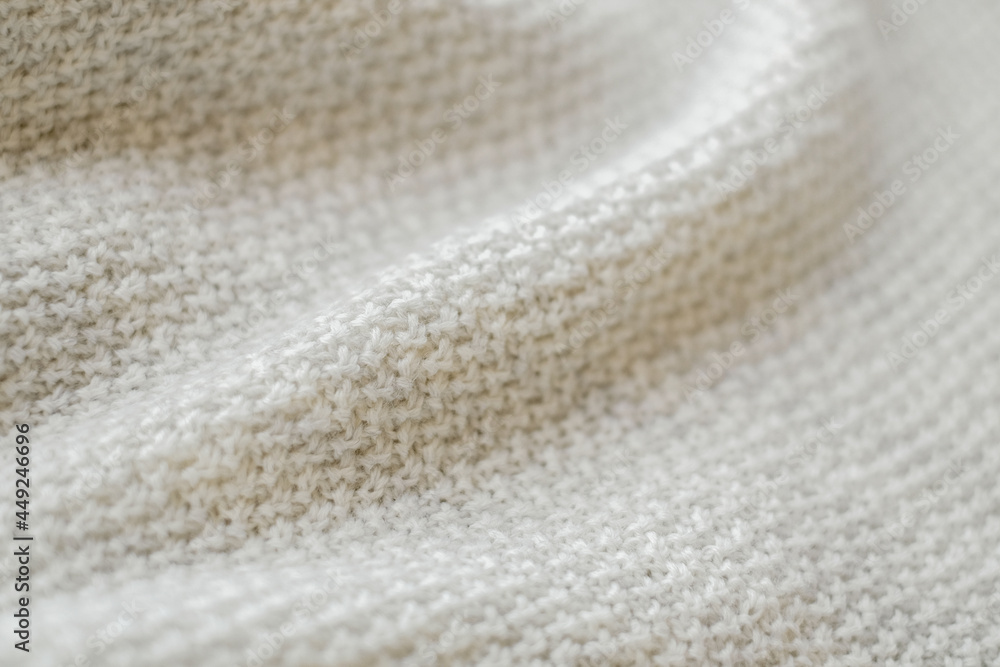 White natural texture of knitted wool textile background, cotton fabric close-up White natural texture of knitted wool textile background, cotton fabric close-up