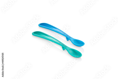 Pair of fun blue and green child spoons isolated