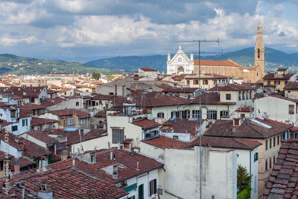 Red rooftops of Florence with the Santa Croce Basilica in the background.
