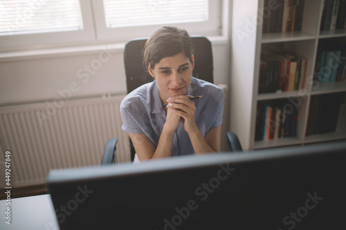 Young businesswoman working long hours from home office